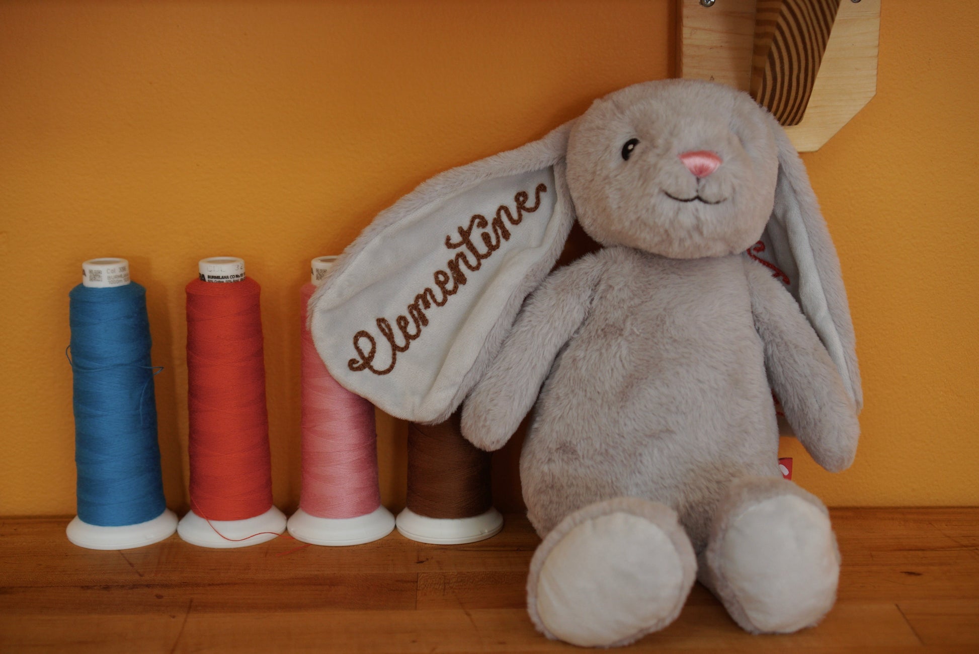 A stuffed bunny for kids with a chainstitched name on the ear
